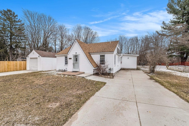 view of front of home with a detached garage, an outdoor structure, fence, a shingled roof, and concrete driveway
