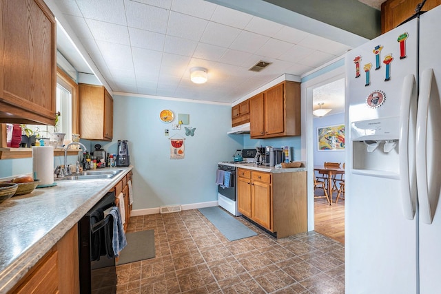 kitchen featuring white appliances, visible vents, under cabinet range hood, light countertops, and a sink