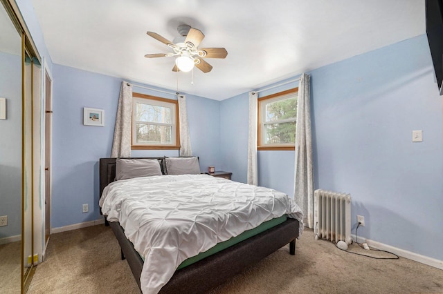 bedroom featuring radiator heating unit, multiple windows, baseboards, and carpet floors
