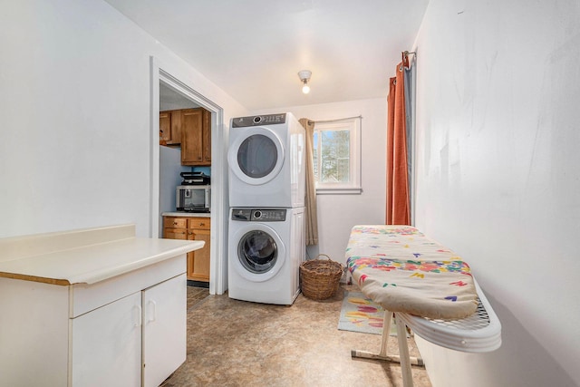 washroom with stacked washer / dryer and laundry area