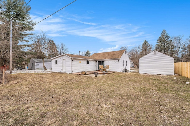 back of property featuring a yard, a patio area, fence, and an outdoor structure