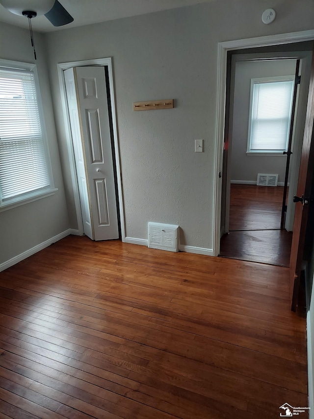 3857 14th St, Wyandotte, MI 48192 - unfurnished bedroom with baseboards, wood-type flooring, and visible vents