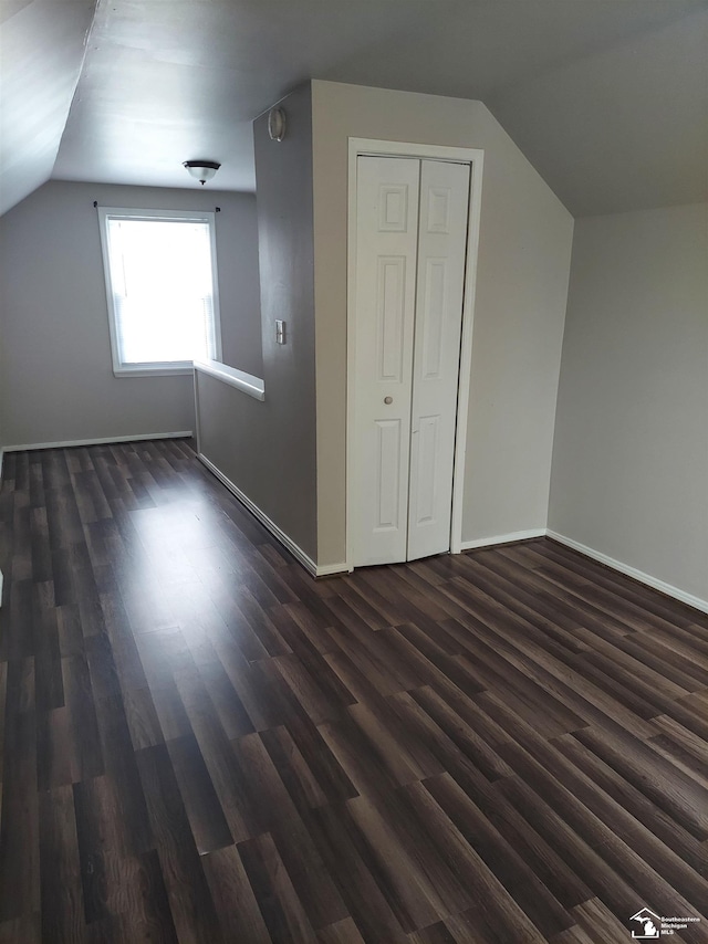 3857 14th St, Wyandotte, MI 48192 - bonus room with dark wood-style floors, baseboards, and lofted ceiling