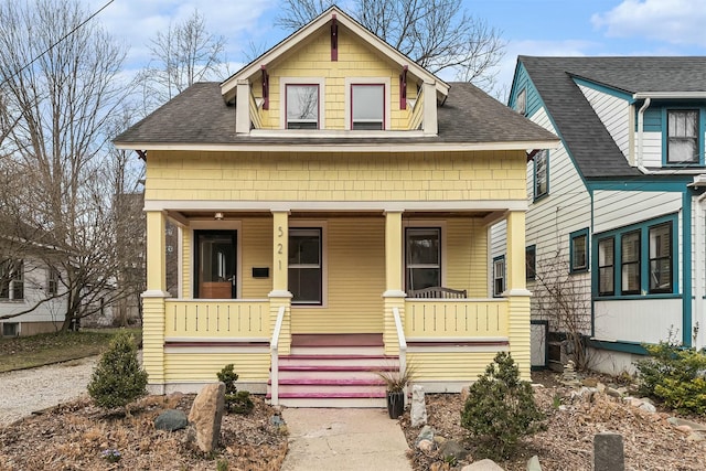 view of front of home with a shingled roof and covered porch