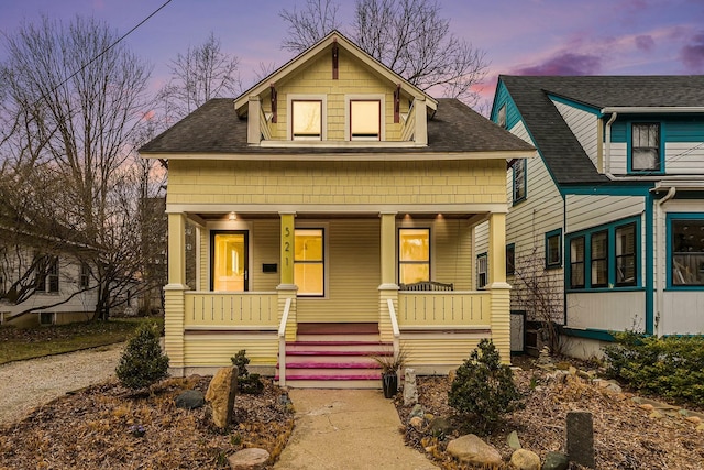 view of front of home with a porch and a shingled roof