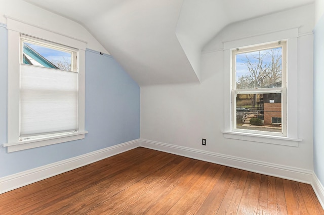 bonus room with baseboards, plenty of natural light, and hardwood / wood-style floors