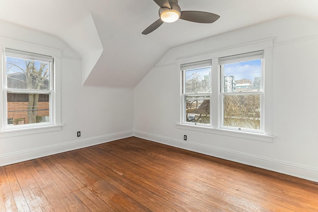 bonus room with ceiling fan, baseboards, vaulted ceiling, and hardwood / wood-style flooring