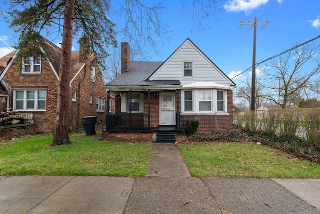 9661 Asbury Park, Detroit, MI 48227 - bungalow-style home featuring a porch, a chimney, a front lawn, and brick siding