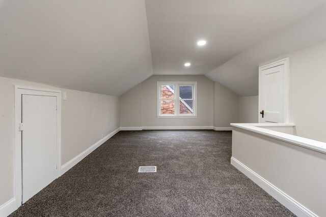 9661 Asbury Park, Detroit, MI 48227 - additional living space featuring visible vents, baseboards, dark carpet, and lofted ceiling