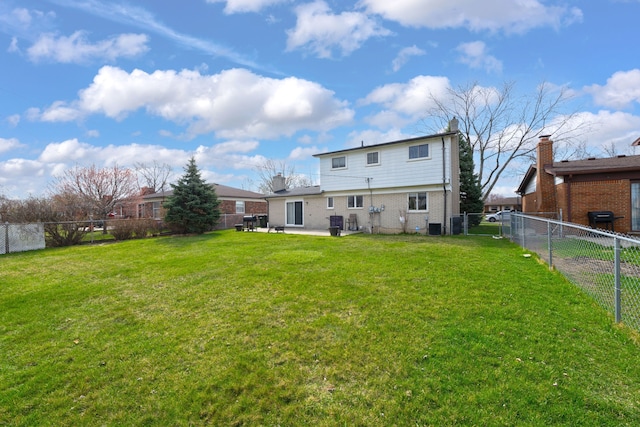 11151 Brougham Dr, Sterling Heights, MI 48312 - rear view of property with brick siding, a fenced backyard, a lawn, and a patio area
