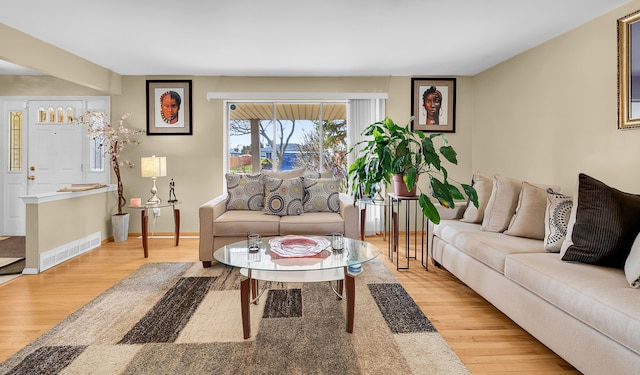 11151 Brougham Dr, Sterling Heights, MI 48312 - living room with wood finished floors, baseboards, and visible vents