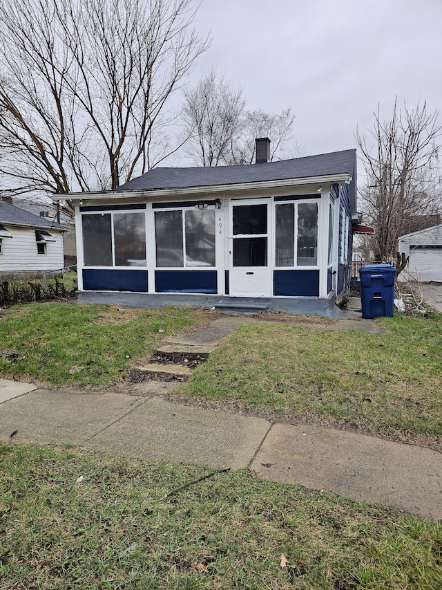 494 Polk Ave, River Rouge, MI 48218 - bungalow-style home with a front yard, a sunroom, and a chimney