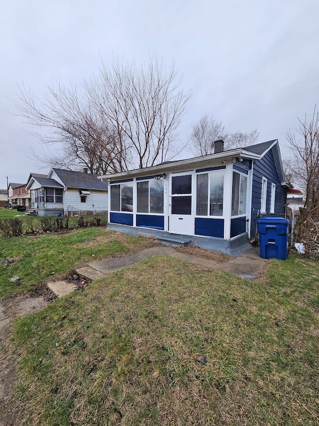 494 Polk Ave, River Rouge, MI 48218 - rear view of property with a lawn and a sunroom