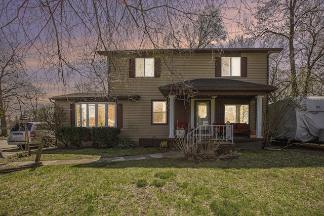 traditional-style home with a yard and covered porch