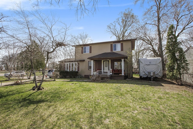 traditional-style house with a front yard and covered porch