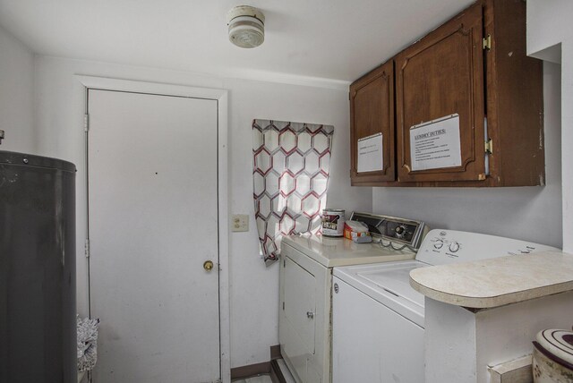 washroom featuring cabinet space and independent washer and dryer