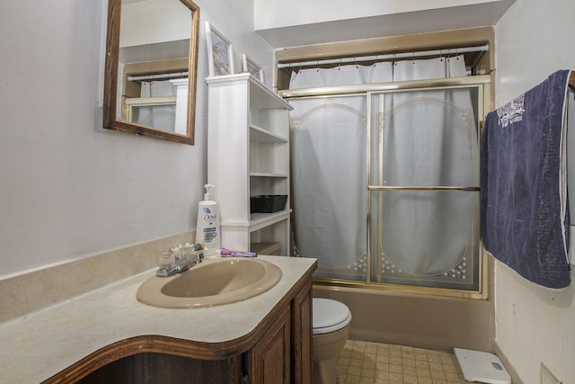 full bathroom with tile patterned floors, toilet, vanity, and shower / bath combination with glass door