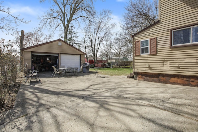exterior space with an outbuilding, a detached garage, and fence