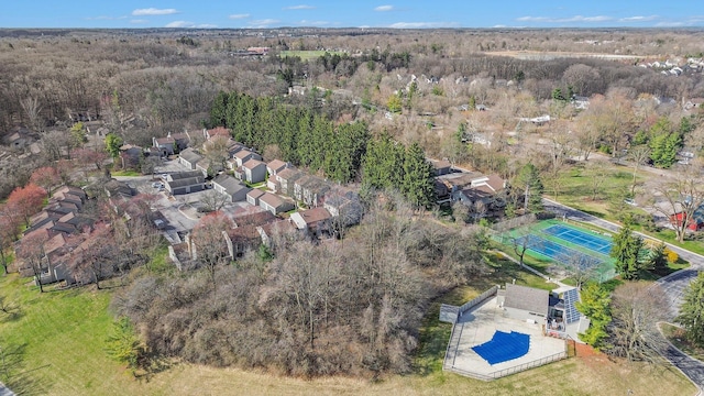 birds eye view of property featuring a wooded view