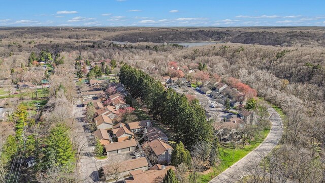 birds eye view of property featuring a wooded view, a residential view, and a water view
