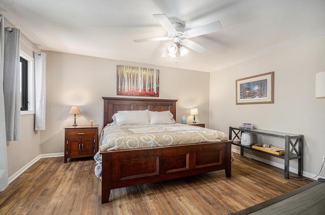 bedroom featuring wood finished floors, baseboards, and a ceiling fan