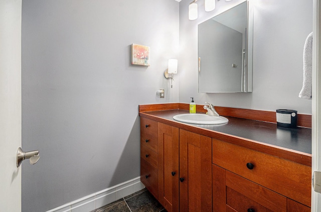bathroom featuring tile patterned floors, vanity, and baseboards