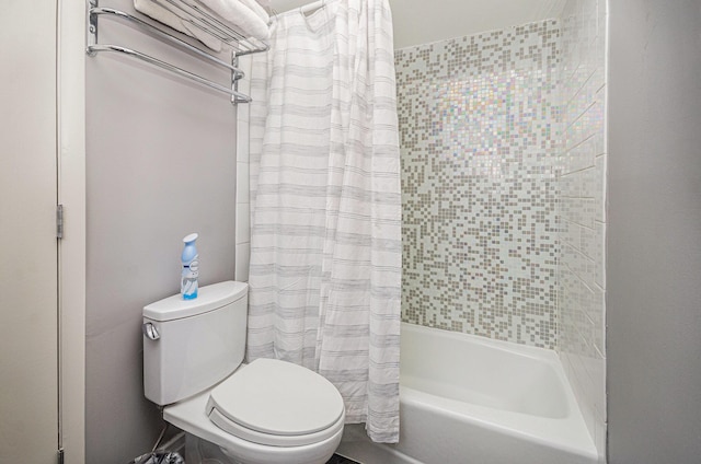 bathroom with shower / tub combo with curtain and toilet