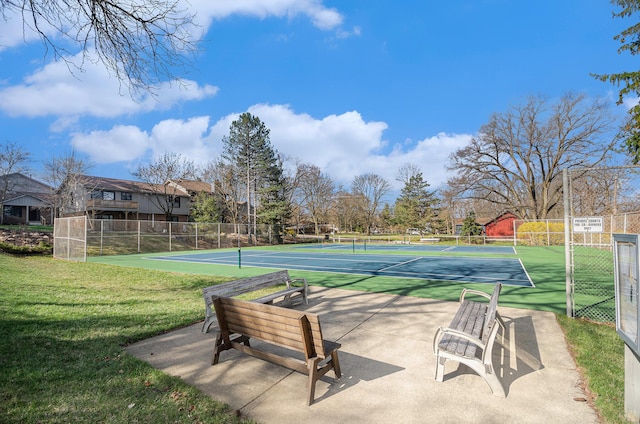 view of sport court featuring a yard and fence