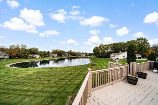 deck featuring a water view and a lawn