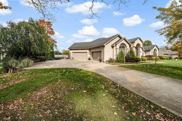 view of front facade featuring a front lawn, a garage, driveway, and stucco siding