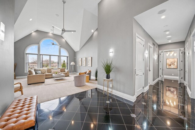 interior space featuring high vaulted ceiling, baseboards, granite finish floor, and recessed lighting