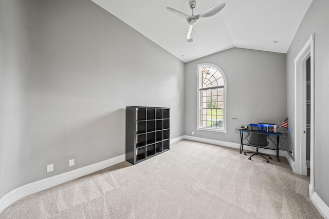 carpeted office space featuring ceiling fan, baseboards, and lofted ceiling