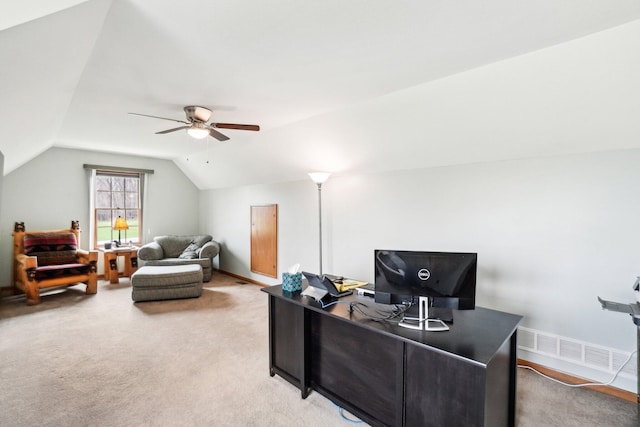 home office with light colored carpet, visible vents, a ceiling fan, and vaulted ceiling