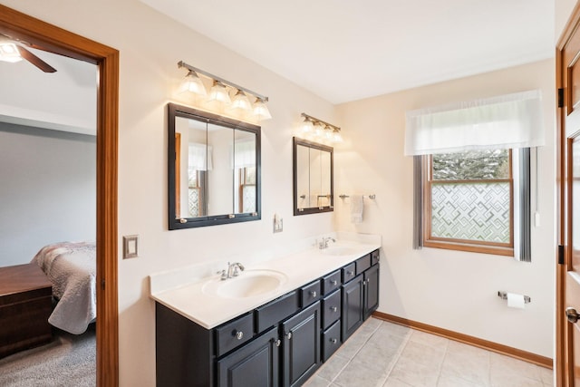 ensuite bathroom with a sink, ensuite bathroom, double vanity, and a ceiling fan