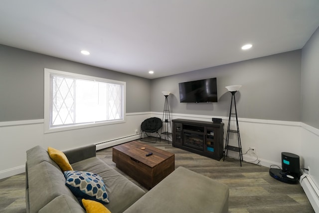 living area with baseboard heating, wood finished floors, wainscoting, and recessed lighting
