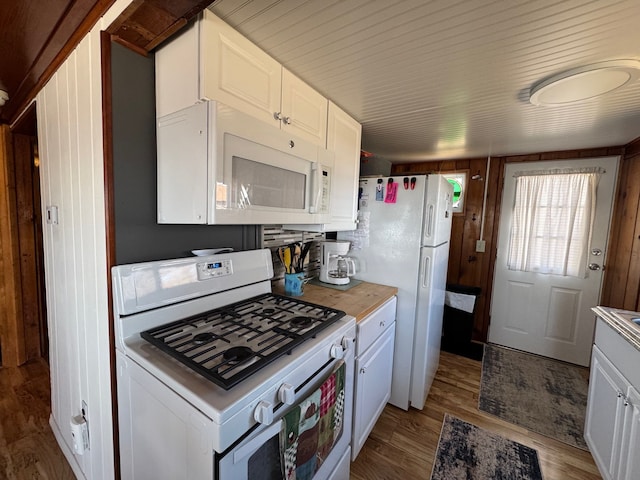 kitchen with light countertops, white cabinets, light wood-style floors, and white appliances