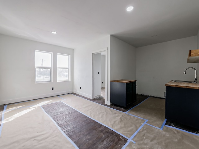 11765 Glenfield St, Detroit, MI 48213 - interior space with a wood stove, a sink, dark cabinetry, and wooden counters