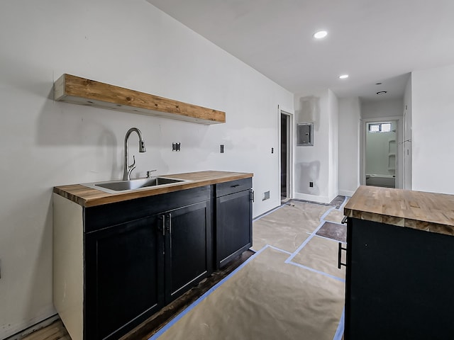11765 Glenfield St, Detroit, MI 48213 - kitchen featuring a sink, recessed lighting, dark cabinetry, and butcher block counters