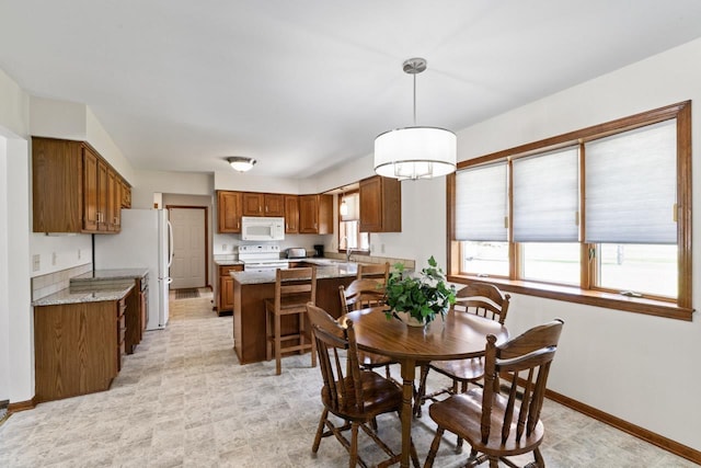 5802 Pratt Rd, Lapeer, MI 48446 - dining area featuring baseboards and light flooring