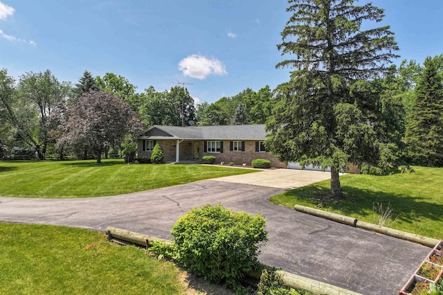 5802 Pratt Rd, Lapeer, MI 48446 - ranch-style house with driveway, a front yard, and brick siding