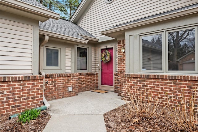 21304 Juniper Ct Unit 69, Farmington Hills, MI 48336 - doorway to property featuring brick siding and roof with shingles