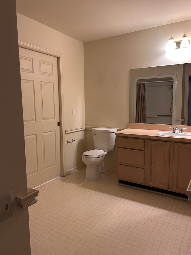 bathroom featuring toilet and vanity