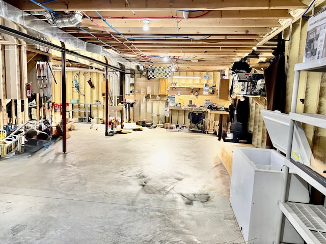 unfinished basement with a workshop area