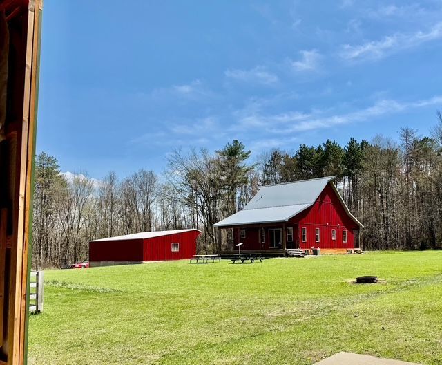 view of yard featuring a barn and an outbuilding