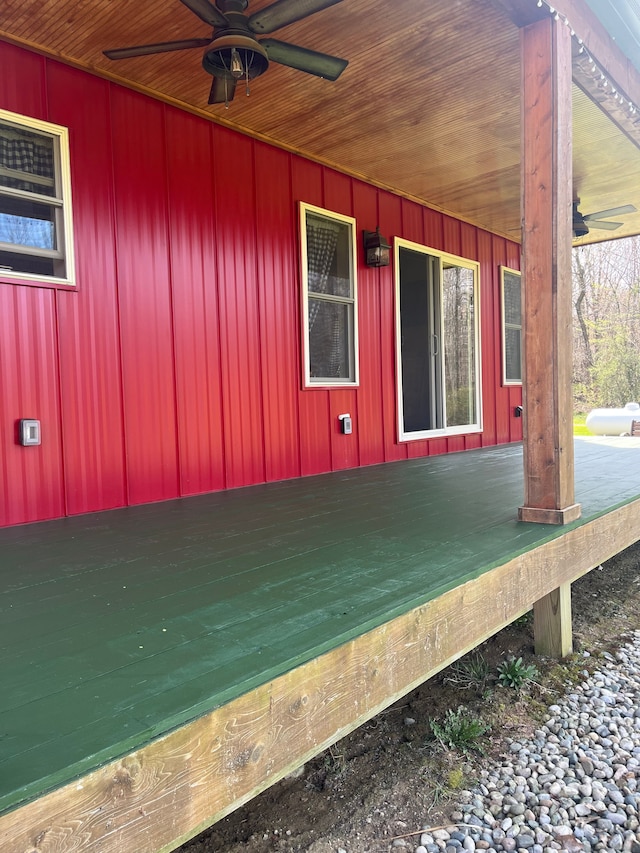 view of side of home with a wooden deck and ceiling fan