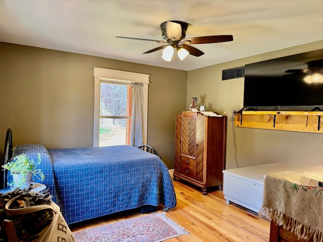 bedroom with ceiling fan, visible vents, and light wood-style flooring