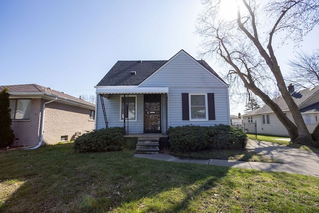 bungalow featuring roof with shingles and a front yard