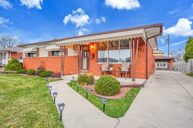 32334 Gloede Dr, Warren, MI 48088 - view of front of house featuring brick siding, concrete driveway, a porch, and a front lawn