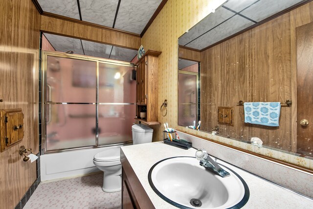 32334 Gloede Dr, Warren, MI 48088 - bathroom with crown molding, vanity, toilet, bath / shower combo with glass door, and wooden walls