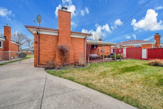 32334 Gloede Dr, Warren, MI 48088 - back of house featuring a yard, a patio area, a chimney, fence, and brick siding